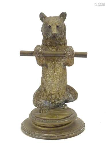 A Victorian novelty brass desk inkwell / standish modelled as a standing bear holding a staff, his