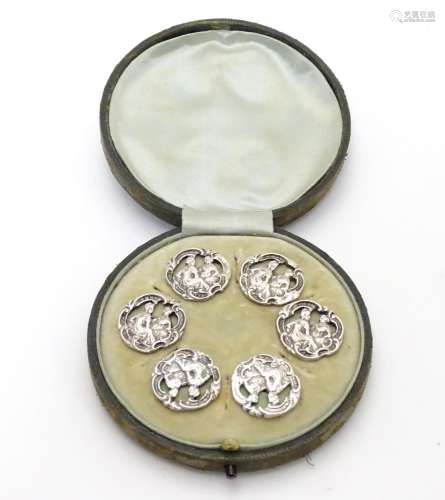A cased set of 6 white metal buttons. Marked to reverse with Registered design no 352928. each