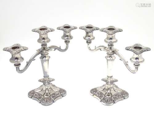 A pair of silver plate candelabra with fruiting vine decoration . Approx 10