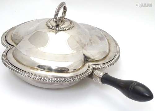 A silver plate serving dish and cover of trefoil form with three sections within and having ebonised