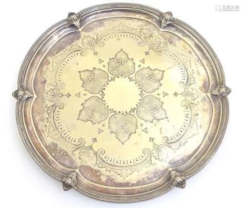 A silver plate salver with engraved decoration. Approx 15