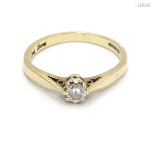 A 9ct gold ring set with diamond solitaire. The diamond approx 1/8
