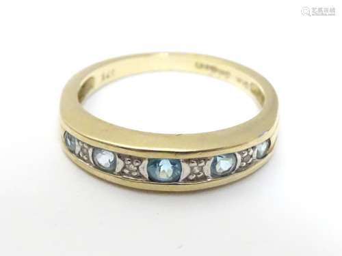 A 9ct gold ring set with topaz and diamond in a linear setting. ring size approx K 1/2 Please Note -