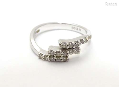 An 18ct white gold ring set with three bands of 5 white stones. Ring size approx H Please Note -