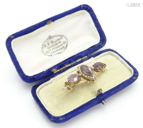 A Victorian brooch set with facet cut amethyst and seed pearls 1 1/2