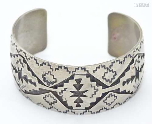 A North American bangle formed bracelet with incised geometric decoration. Marked Sterling Please