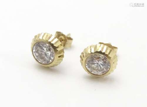 A pair of 9ct gold stud earrings set with paste stones. Approx. 1/4