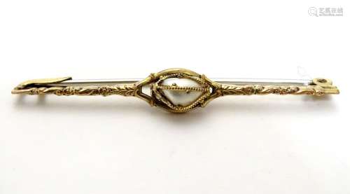 A yellow metal bar brooch set with central pearl 2