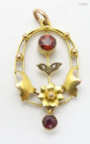 An Art Nouveau pendant set with garnets and seed pearls. Approx 1 1/4