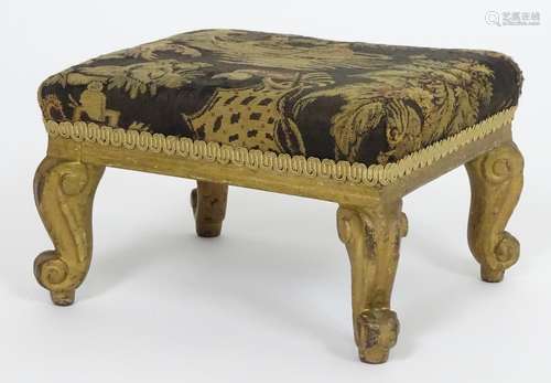 An / early 20thC footstool with an upholstered top above four cabriole legs terminating in