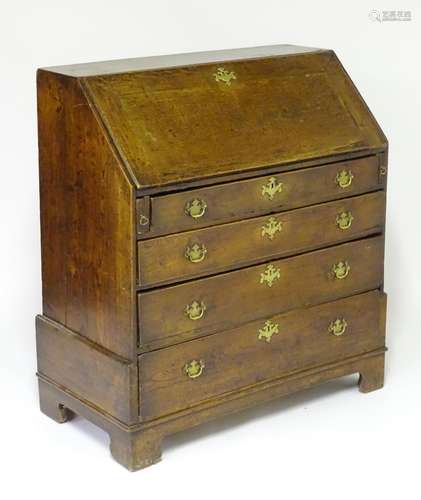 A mid 18thC oak bureau with a fall front opening to show a fitted interior, the base comprising four