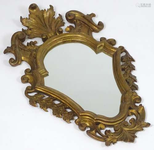 An early / mid 20thC giltwood mirror with a carved floral frame. 28