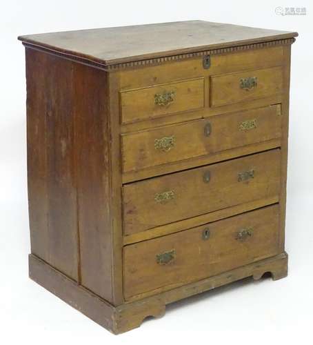 A Georgian fruitwood mule chest with a rectangular top above a dentil carved frieze, having three