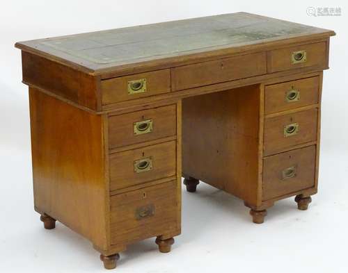 An early / mid 19thC mahogany double pedestal campaign desk with an inset leather top above a single