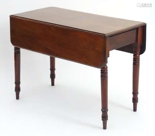 A 19thC mahogany Pembroke table with drop flaps and short end drawer, the table raised on turned