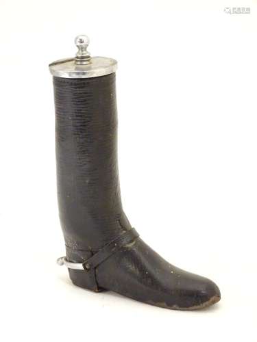 A 20thC table lighter modelled as a riding boot with a leather finish. Approx. 6 1/4