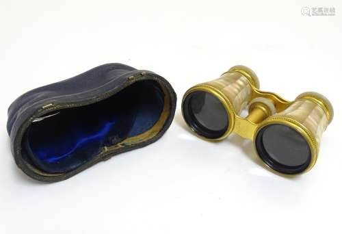 A late 19th / early 20thC pair of gilt brass and mother of pearl opera / theatre glasses. Approx.