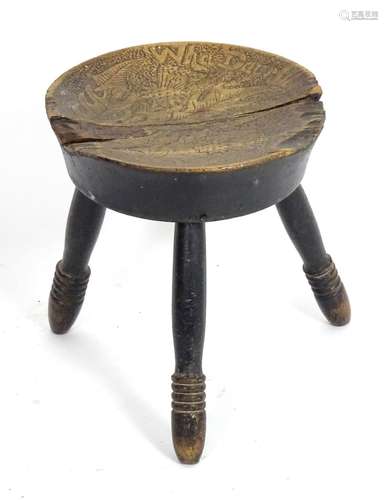 An 18thC country made elm stool, with a circular seat and three turned tapering legs. 11