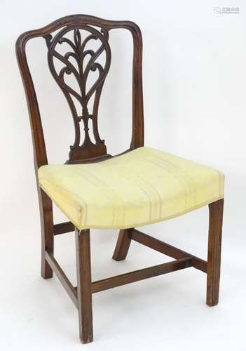 A late 18thC mahogany side chair with a shaped and carved cresting rail, pierced back splat above