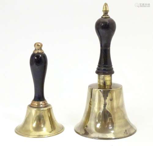 Two early 20thC brass hand bells with ebonised and turned handles. Largest approx. 7