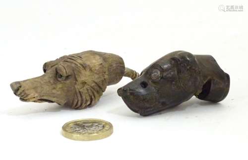 Two late 19th / early 20thC carved wooden dog heads, one a whistle. Largest approx. 2 1/2