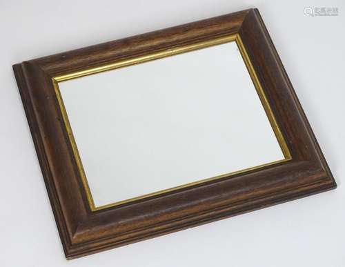 An early 20thC mirror with an oak frame and gilt surround. 18