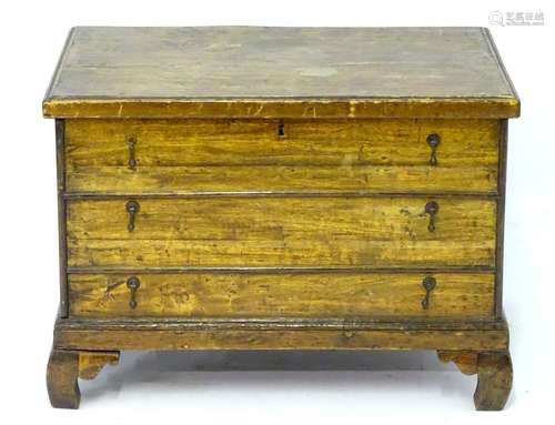 An 18thC elm box with a moulded lid and three false drawers with Dutch drop handles, the box