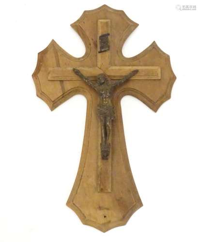 An early 20thC wooden crucifix with a cast model of Jesus Christ on the cross below an INRI scroll