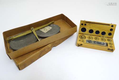 A 20thC set of scientific balance scales by P. Harris & Co. Together with cased weights. Please Note