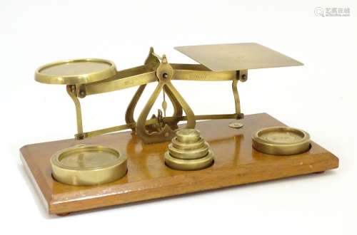 A set of Victorian brass postal scales with six graduated weights. Approx. 10