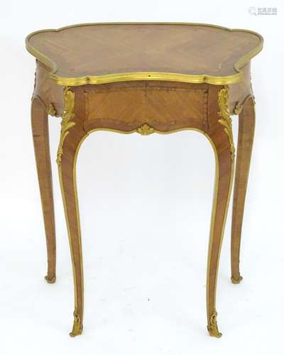 A late 19thC kingwood table in the manner of Francois Linke with a shaped top, gilt stringing and