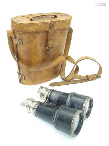 A pair of Binoculars / Field Glasses by Chevalier, Paris, with sunshades and associated leather case