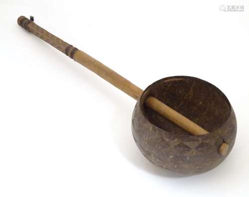 Ethnographic / Native / Tribal: A late 19th / early 20thC ladle with a carved handle incised with
