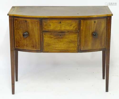 A late 18thC Sheraton style mahogany sideboard with a bowed crossbanded top above an inlaid frame