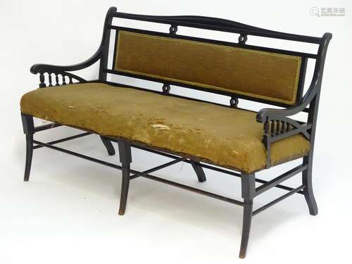 A late 19thC Aesthetic movement ebonised sofa in the manner of E.W Godwin. The sofa having a