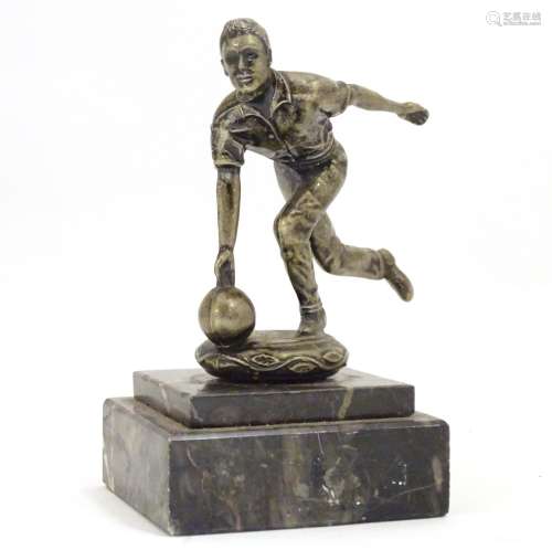 A 20thC cast figure modelled as a man bowling, on a stepped marble base. Approx. 5 1/4