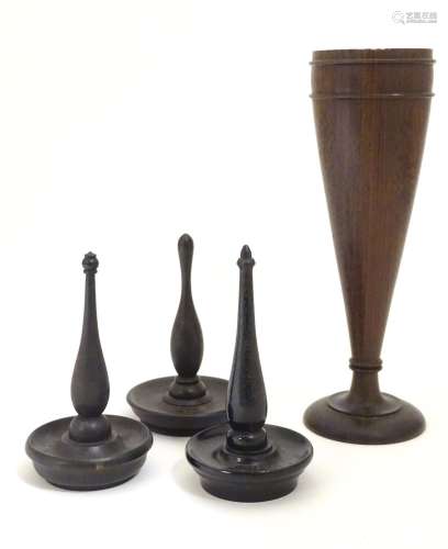 Four items of early 20thC treen, comprising three ring trees / jewellery holders and a spill vase.
