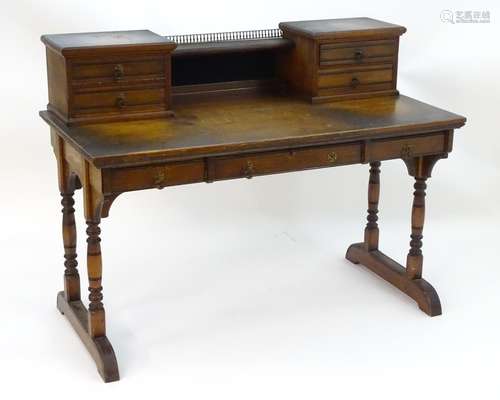 A late 19thC Aesthetic movement desk by Gillows of Lancaster with two banks of drawers flanking a