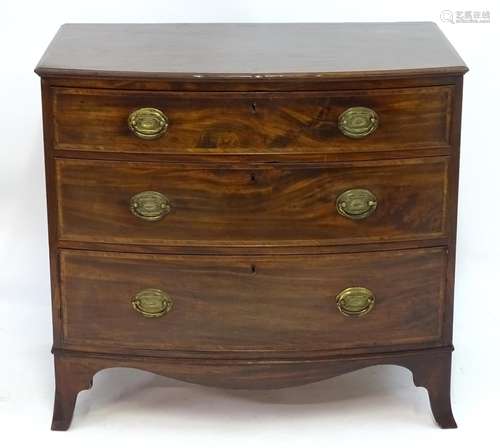 A Regency mahogany bow fronted chest of drawers with a feather banded and decoratively strung top