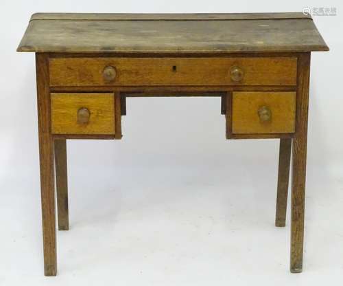 A late 18thC oak lowboy with a rectangular top above a single long drawer and two short drawers with