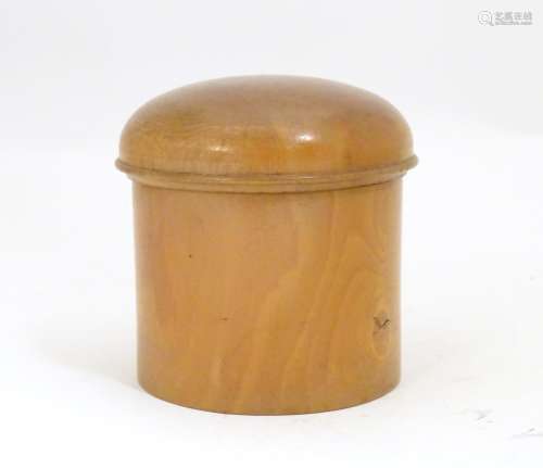 A 19thC treen turned boxwood cylindrical pot with a domed lid. Approx. 3 1/4