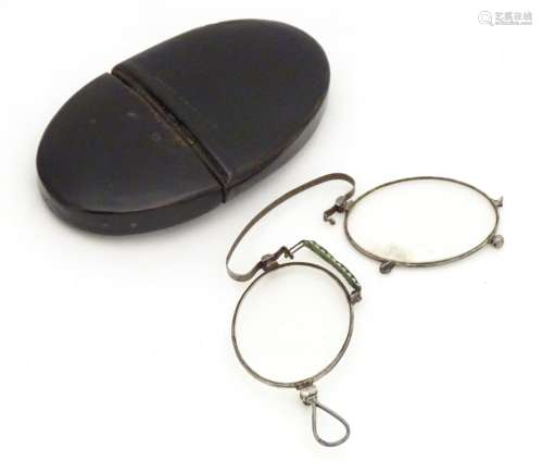 19thC folding pince-nez glasses contained within an oval papier mache case with inlaid detail.