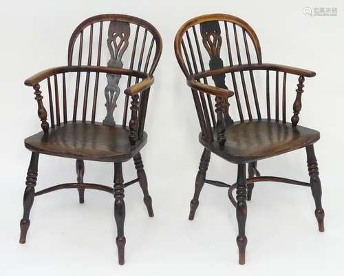 A pair of early 19thC double bow back Windsor chairs of yew, beech and elm construction. With