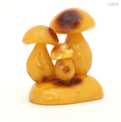 A late 19th / early 20thC amber carving modelled as a group of three toadstools. Approx. 2