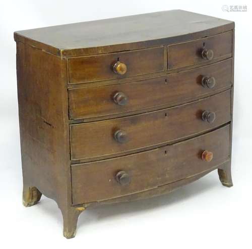 A late 18thC mahogany bow fronted chest of drawers with two short over three long drawers with