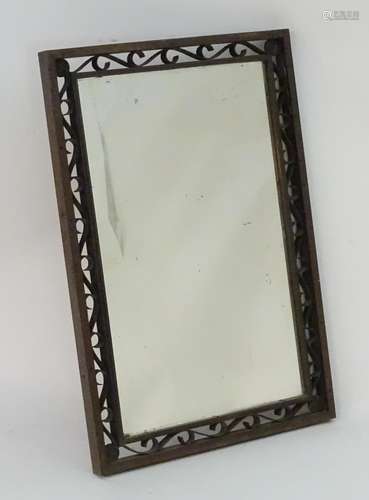 A 20thC mirror with a scrolled bronze surround and a bevelled mirror to the centre. 24? wide x 37?