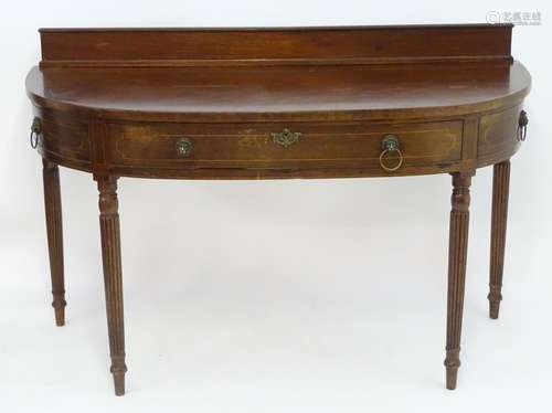 A mid 19thC mahogany serving table, with an up stand above a bowed front with decorative