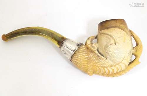 An early 20thC cased carved meerschaum pipe, the bowl formed as an eagle talon, joined to the