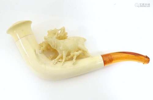 An early 20thC cased ladies' carved meerschaum pipe, the bowl formed as a stag amongst foliage, with