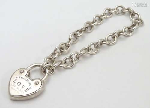A chain link bracelet with silver heart shaped padlock style clasp marked 'Love' ' Please return
